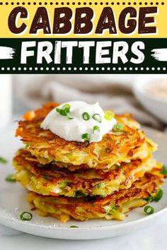 a stack of crab cake fritters on a plate with sour cream and green onions