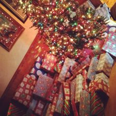 a christmas tree with presents under it