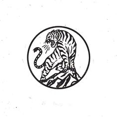 a black and white drawing of a tiger in a circle with chinese writing on it