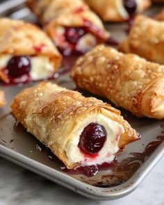 croissants filled with jelly and cream on a baking sheet, ready to be eaten