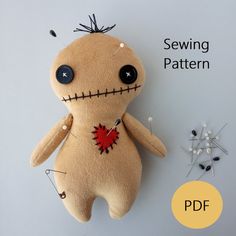 a stuffed doll with pins attached to it's back and the sewing pattern below