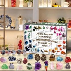 there are many different kinds of rocks on the shelf in this display case, including crystals