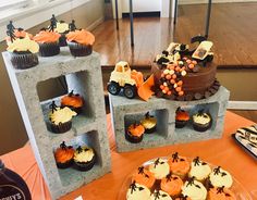 some cupcakes are sitting on top of cinder blocks and decorated with halloween decorations