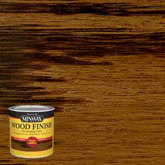 a can of wood finish sitting on top of a wooden table