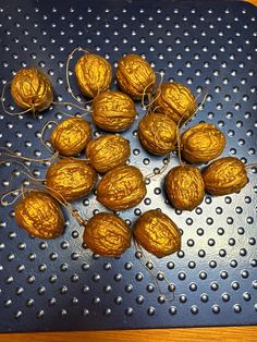 some nuts are sitting on a metal tray with string wrapped around them and ready to be eaten