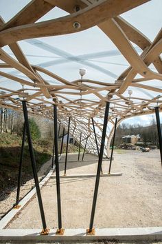 an outdoor covered walkway with metal poles