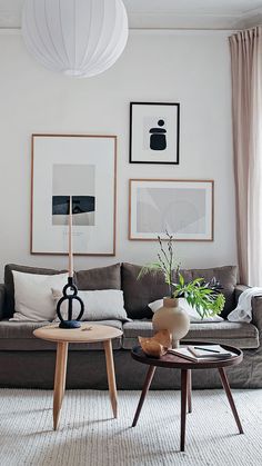 a living room filled with furniture and pictures on the wall above it's coffee table