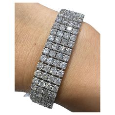 SKU: 103106 Dramatic 26.65 carat white diamond bangle bracelet sure to add shimmer and shine. With 200 total number of round diamonds your wrist will shine with every move that you make. Bracelet width: 13.3mm and fits a 3 inch wrist Metal: 18k White Gold Diamond Weight: 200 round brilliant cut diamonds 26.64ct tw Make Bracelet, Diamond Bangle Bracelet, Bracelet Tennis, Diamond Bangles Bracelet, Shimmer And Shine, Shimmer N Shine, Diamond Bangle, Statement Bracelet, Tennis Bracelet