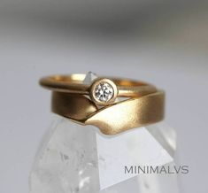 a gold ring with a diamond on it