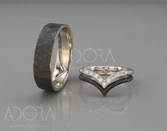 two wedding rings with diamond accents on the sides and inlays to each other