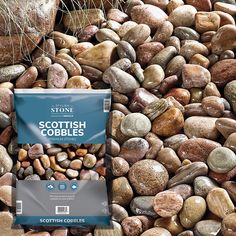 a bag of scottish cobbles sitting on top of a pile of rocks and gravel