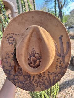 Unleash your individuality with our Custom Burned Hats, where your story becomes wearable art. Each hat is meticulously crafted and hand-burned to capture your unique journey, just like a tattoo but on a stylish accessory. Why You'll Love It: 100% Custom: Every design is tailored to your personal story, interests, and style. Artisan Craftsmanship: Hand-burned with precision and care, ensuring a high-quality, one-of-a-kind piece. Express Yourself: From birth flowers and landscapes to meaningful s Hat Burn Designs, Cactus Burned Hat, Pyrography Hats, Hat Burning Designs, Burning Hats, Burned Hats, Like A Tattoo, Cowboy Hat Styles, Hat Burning