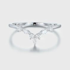 a white gold ring with three pear shaped diamonds