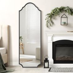 a living room with a fireplace and mirror