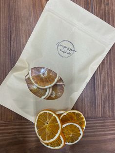 three orange slices sitting on top of a piece of white paper next to a bag