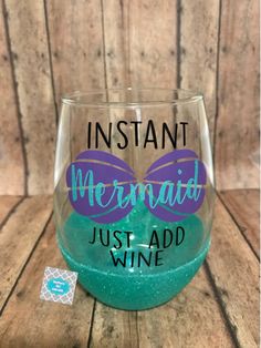 a wine glass with the words instant mermaid just add wine in purple and teal