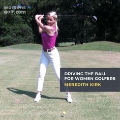 a woman swinging a golf club at a ball on the grass with trees in the background