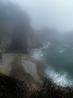 the beach is covered in fog and water