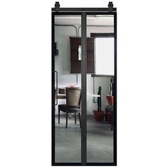 an open glass door in the middle of a room