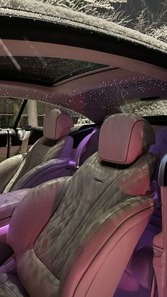 the interior of a car with pink leather seats and purple dash cloth upholster