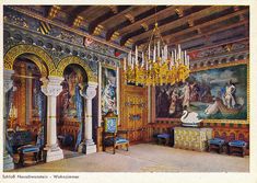 an ornately decorated room with chandeliers and paintings on the wall behind it