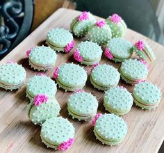 a cutting board topped with cookies covered in frosting