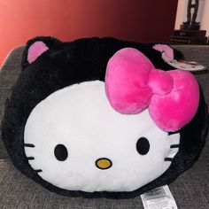 a hello kitty stuffed animal sitting on top of a couch