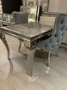 a marble dining table and chairs in a room