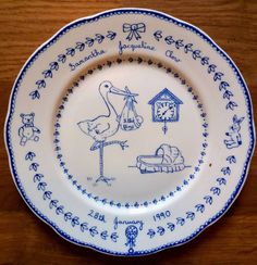 a blue and white plate with an image of a stork