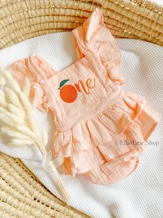 Make your little girl's first birthday sweeter with our adorable cotton muslin romper, perfect for a "One Little Cutie" or a clementine/orange theme!  This charming outfit is designed to add a delightful touch to her special day. Crafted with soft muslin fabric, this romper ensures comfort and coziness for your precious one. The tutu ruffle skirt adds a whimsical flair, making it a perfect choice for her birthday celebration. The highlight of this outfit is the beautifully embroidered clementine Birthday Theme Outfits, One Little Cutie First Birthday, Our Cutie Is One, Little Cutie First Birthday, Orange 1st Birthday Party, Clementine First Birthday, Cutie Themed First Birthday, Orange First Birthday, Cute Peach Cotton Dress