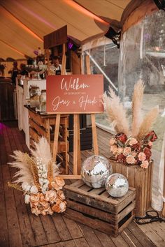 there is a sign that says welcome to the guests at this outdoor wedding reception with flowers and pamodils