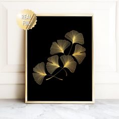 a black and gold ginkoket print on a wall