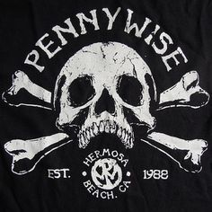 a black t - shirt with white skull and cross bones on the front that says pennywise