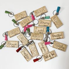 wooden keychains with different types of name tags on them, all in various colors