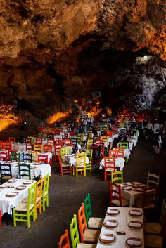 many tables and chairs are set up in the cave