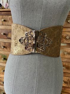 "Wow! This is a really unique vintage Bebe belt. It is super wide, approximately 5 inches and has a gold, iridescent snake print in the front with metal ornamental buckle that hooks. Belt is stretchy and in good condition. Please see photos for details. this is a Pettitt small, so do check measurements please and see photos for details. Size P/S Measurements Full length26 1/2\" Waist 28\" and smaller Width 5\"" Gold Fitted Belt, Vintage Adjustable Gold Belt, Adjustable Gold Belt For Evening, Gold Fitted Belt For Formal Occasions, Formal Fitted Gold Belt, Adjustable Gold Party Belt, Vintage Belts With Removable Buckle For Parties, Gold Embroidered Belt For Party, Gold Embroidered Party Belt