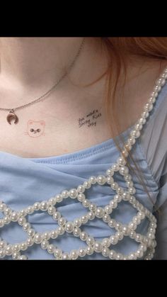 a woman with a small tattoo on her chest