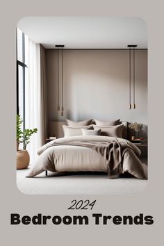 a bed room with a neatly made bed and two hanging lamps above the headboard