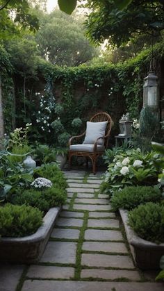 an outdoor garden with lots of plants and flowers on the ground, along with a chair