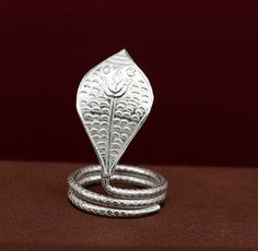 Solid sterling silver handmade gorgeous mini small snake for idol shiva puja or worshipping. best vintage design customized puja accessories, puja article from India. Metal-925 sterling silver. Item type-Tiny snake. Height-3.8 cm. Width-1.8 cm Weight-5.500 grams. Stamped-925. Makes excellent gifting for idols god or puja accessories, Traditional Snake Shape Jewelry Gift, Silver Snake-shaped Wedding Ring, Silver Snake Shape Wedding Ring, Silver Snake Ring With Oxidized Finish For Gift, Silver Snake Ring With Oxidized Finish As Gift, Silver Snake Ring With Oxidized Finish, Shiva Snake, Puja Accessories, Shiva Puja