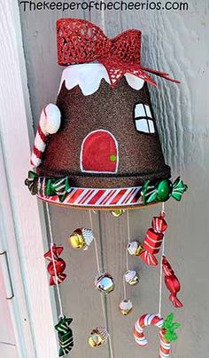 a christmas decoration hanging from the side of a door with candy canes on it