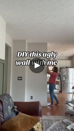 a woman standing in a living room next to a couch