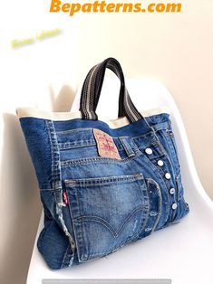 a purse made out of jeans sitting on top of a white chair