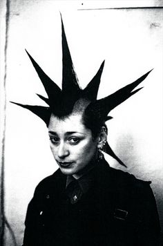 a black and white photo of a woman with spikes on her head