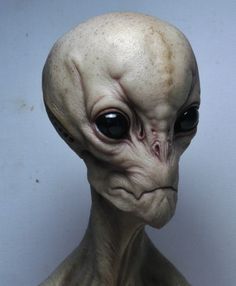 an alien head is shown with black eyes