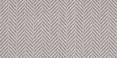 an upholstered gray and white fabric textured with zigzag lines