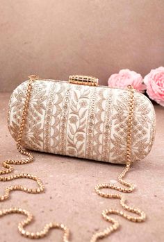 "Put together the perfect wedding look with our Mirai Embroidered clutch. This bag effortlessly delivers the Indian festive look. The luxe gold embroidery is a visual delight to the eyes. The gold tassels and the gold scallop lace add on to the grandeur of the bag. It's the perfect accessory for the bride to be who will be the center of attention.  Color: Cream with gold embroidery Dimensions (LxB): 8\"x4\" Handle length: 47\" Handle drop: 23\" Material: Embroidered poly silk, suede lining, golden metal clutch frame, golden metal sling. Features: metal lock closure, detachable metal sling." Clutch Design, Bridal Clutch Bag, Diwali Party, Clutch Bag Wedding, Fancy Jewellery Designs, Embroidered Clutch, Gift For Bride, Bridal Clutch, Fancy Jewellery