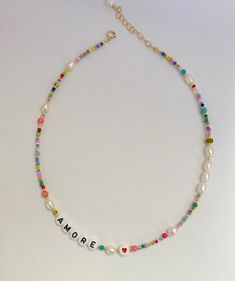 personalized letter necklace/letter bead necklace/beaded letter necklace/freshwaterpearl necklace/mix colour and pearl necklace/friendship This delicate and colourful pearl necklace is a chic detail to your everyday style or as a gift to a loved one. Layer it up with more necklaces for a rich look or wear it alone for a clean and chic style. 🔸 CHOOSE YOUR LETTERS If you want a different word, please write this in the message to seller box when you check out. If you want a personalized necklace Summer Pearl Jewelry With Letter Beads, Trendy Initial Necklace With Letter Beads As Gift, Trendy Initial Necklace With Letter Beads For Gifts, Trendy Beaded Necklaces With Pearl Chain For Gifts, Trendy Pearl Necklace With Letter Beads, Trendy Pearl Chain Beaded Necklace For Gift, Grandma Room, Summer Jewlery, Mixed Beads Necklace