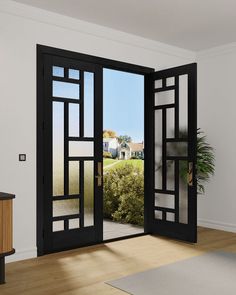 an open door leading to a sunny room with a potted plant in the corner