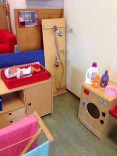 a child's playroom with various toys and furniture in it, including a toy oven